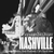Smoker holding a lit preroll on Broadway in Nashville. Cannabis delivery available for summer travelers, party weekends, and CMA Fest at Consider It Flowers.