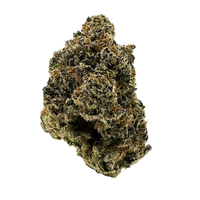 Girl Crush cannabis buds with sweet and savory flavors, featuring chunky forest green nugs and frosty white trichomes.