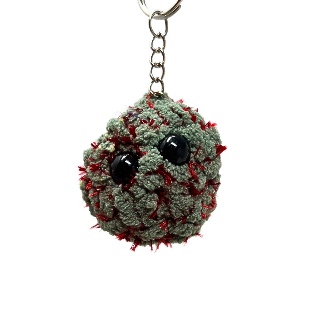 Red-stitched plush nug keychain with black eyes and bold texture. Inspired by the Red Velvet strain. One-of-a-kind and handmade.