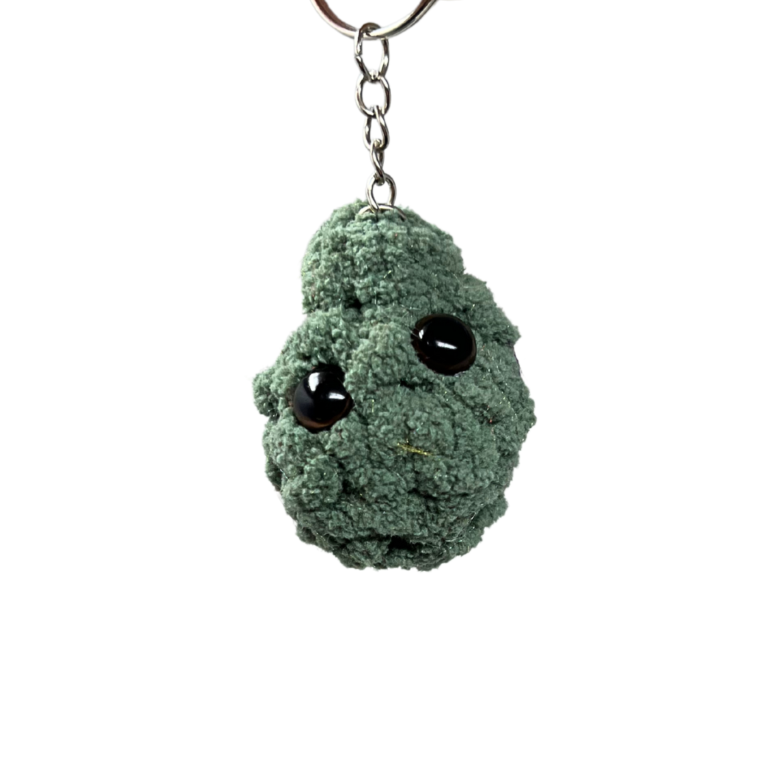 Solid green plush nug keychain with minimal stitching and black eyes, honoring the classic Jack Herer cannabis strain. Handmade in Nashville.