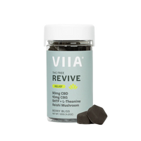 VIIA Revive CBD Relief Gummies in Berry Bliss flavor with two sugar-free coated gummies shown. THC-free, calming support with botanicals.