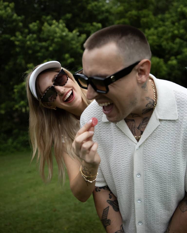 Cute couple golfing and eating indica THC gummy by Consider It Flowers.