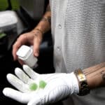 From Consider It Flowers summer 2024 lookbook, a golfer with tattoos is holding Mint Mojito Artisan Gummies in his hand.